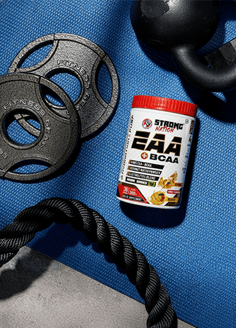 Supplement container labeled 'Strong EAA BCAA' on a blue mat with fitness equipment.